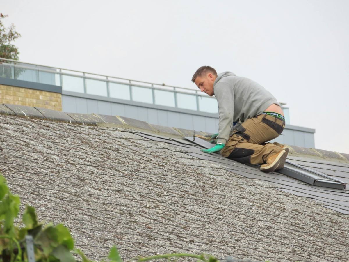 Morgan Roofing — roofer working on slate roof in Bradford